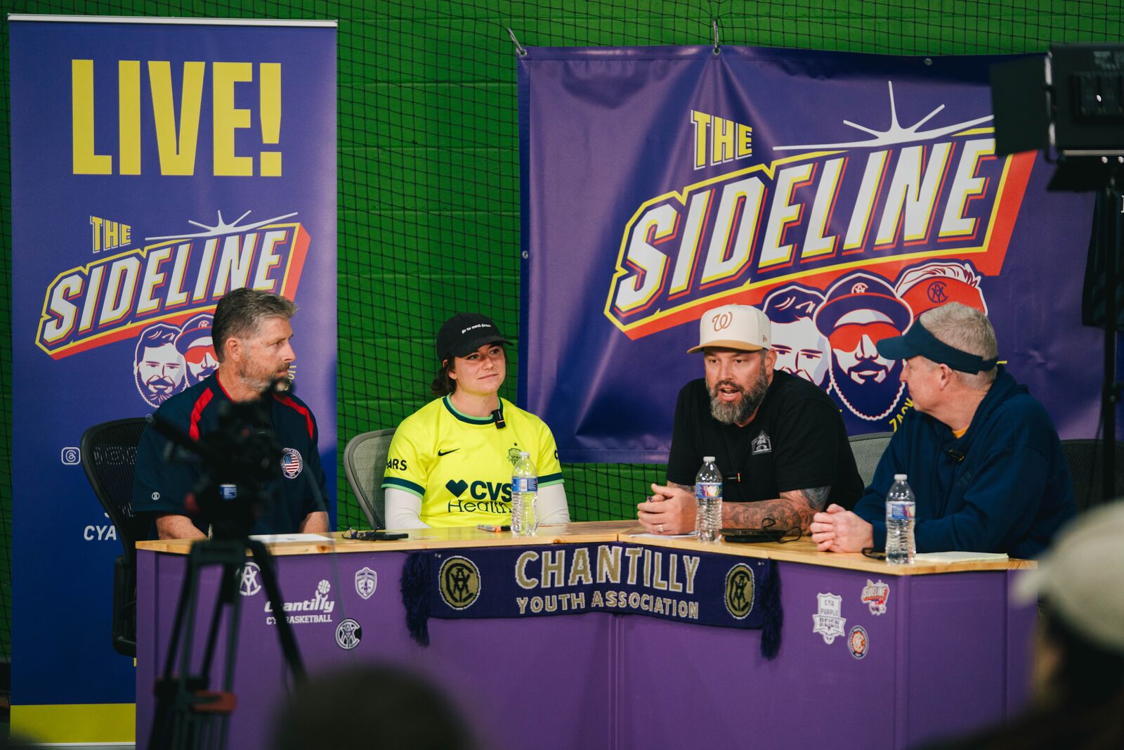 Kate Wiesner seated with Sideline Podcast hosts during a live interview at The Fieldhouse.